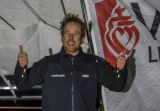 Conrad Colman with a bright smile and tired eyes as he crosses the finish line of his 2nd Vendee Globe in the middle of the night