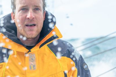 Conrad Colman is sailing in sporty conditions and he's getting wet as well as the camera taking the pictures that has drops all over it