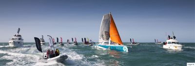 Conrad's arrival in 2016, he dismasted a few days before the finish and arrives with a jury rig that is very colorfull with orange storm jib, his boat is surrounded by motor boats welcoming him back